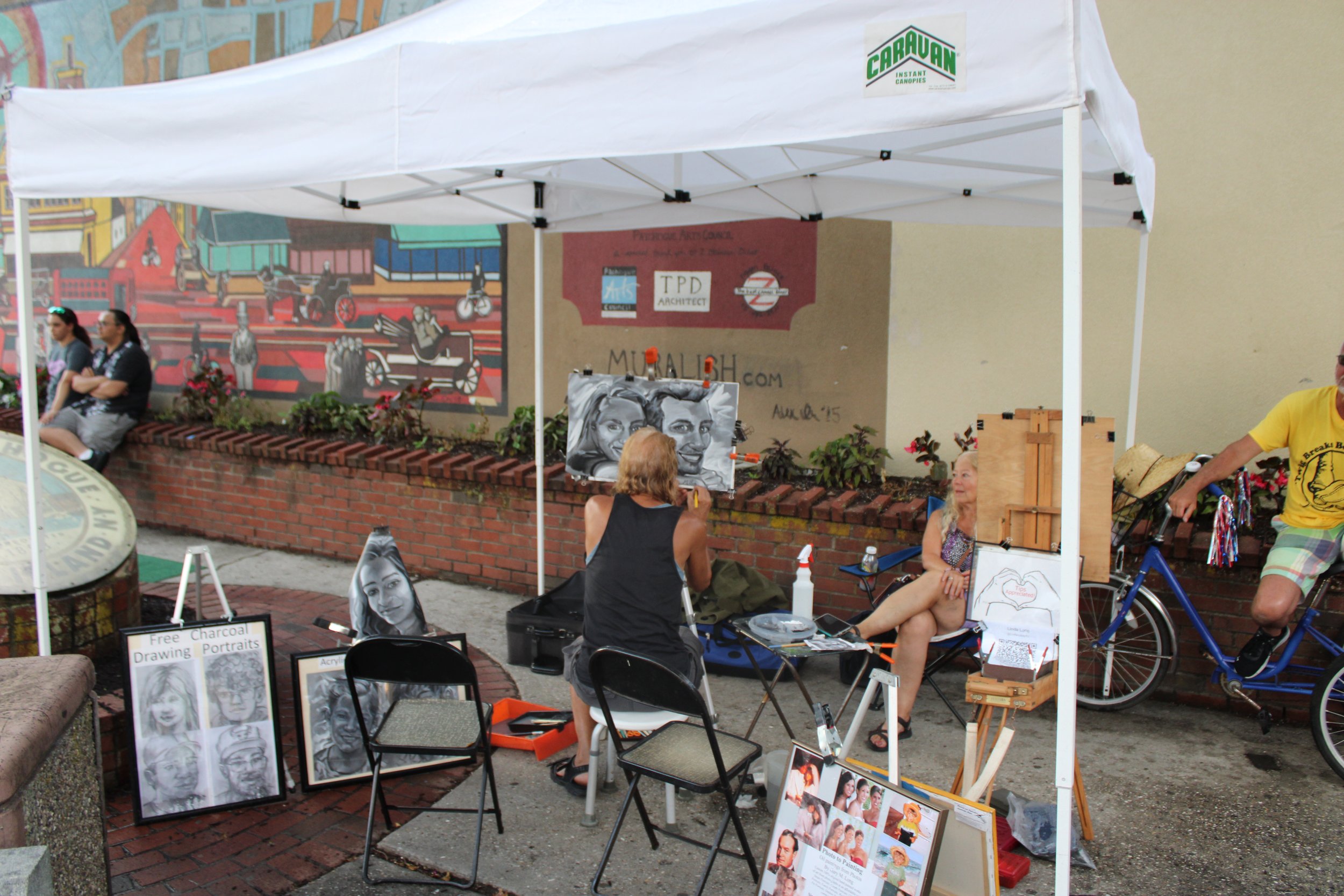 Artist works near the Arts Stage