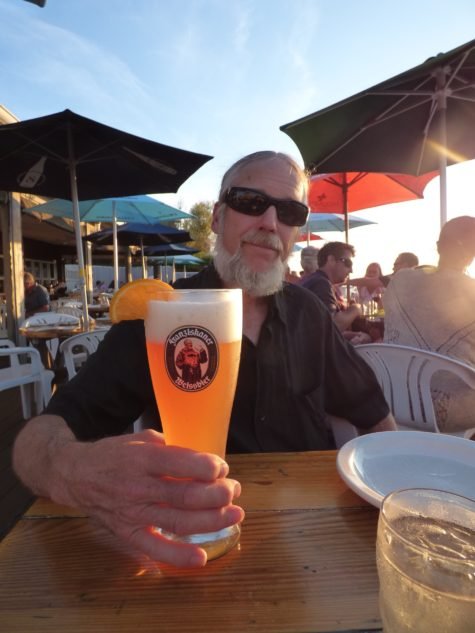 Best seat in the house: John McCollum enjoys his crisp, cool "Franziskaner Weissbier." One of the many fine beers Maguire's offers.