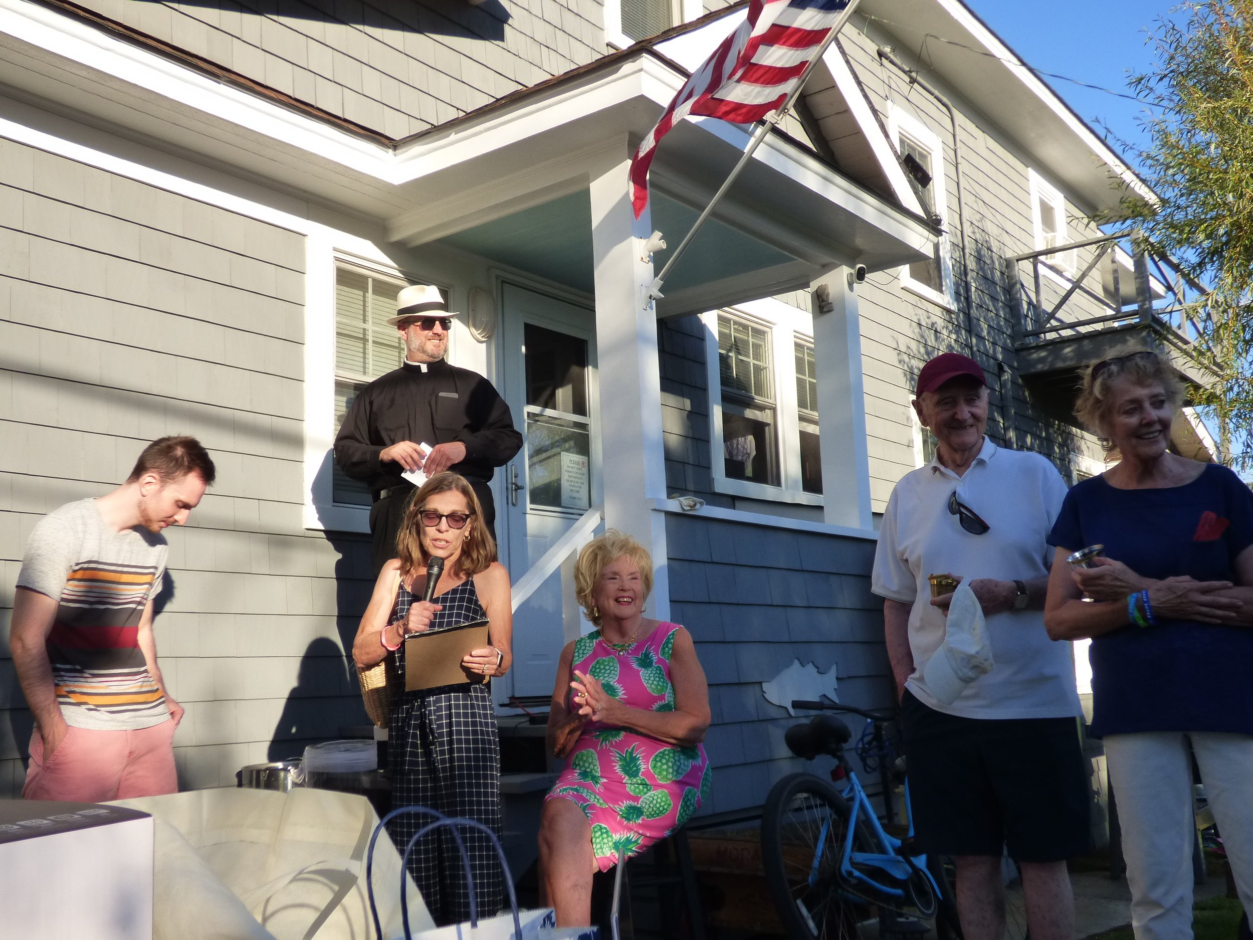 Judith Russell reading the raffle winner by the rectory.