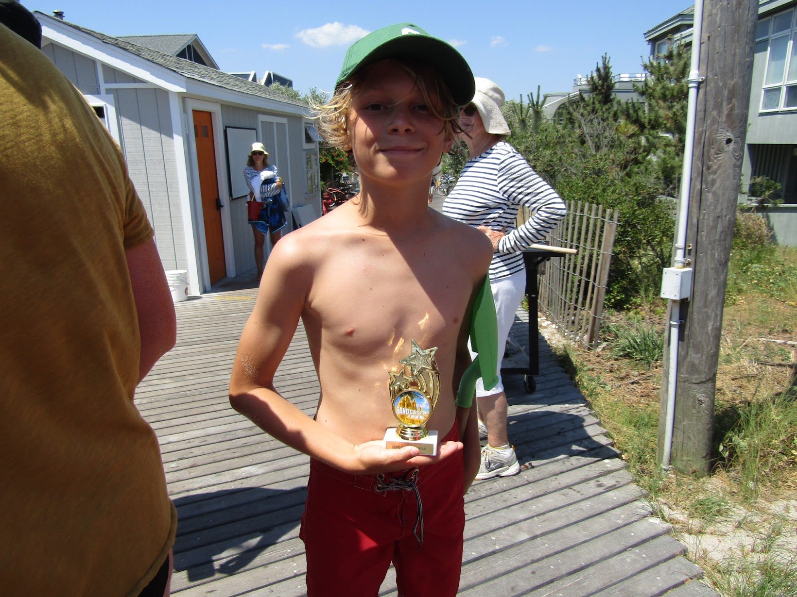 Holding the first place trophy for the Recycle team, who named their creation “Keep Our Beaches Clean.” (Copy)