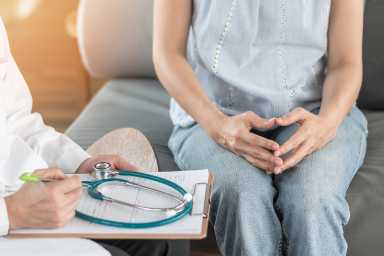 Doctor or psychiatrist consulting and diagnostic examining stressful woman patient on obstetric – gynecological female illness, or mental health in medical clinic or hospital healthcare service center