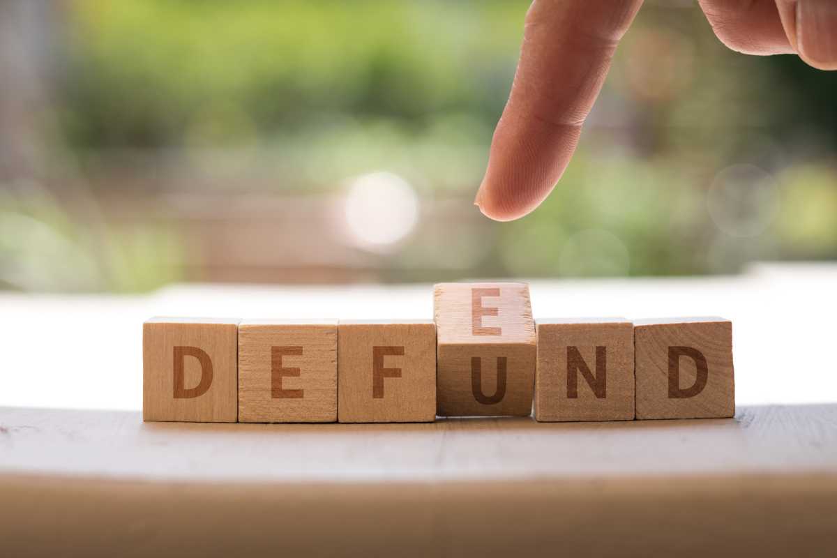DEFEND DEFUND Police concept on wood blocks