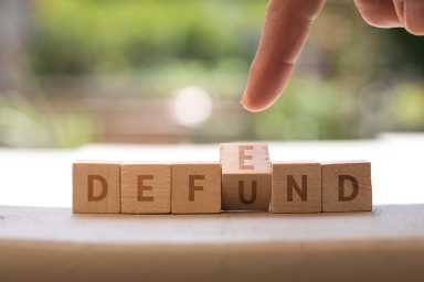 DEFEND DEFUND Police concept on wood blocks
