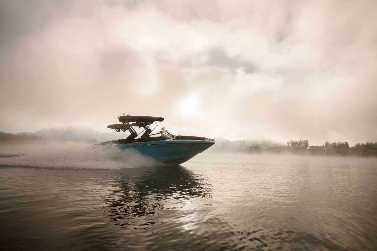 bright blue motorboat quickly floating on the water