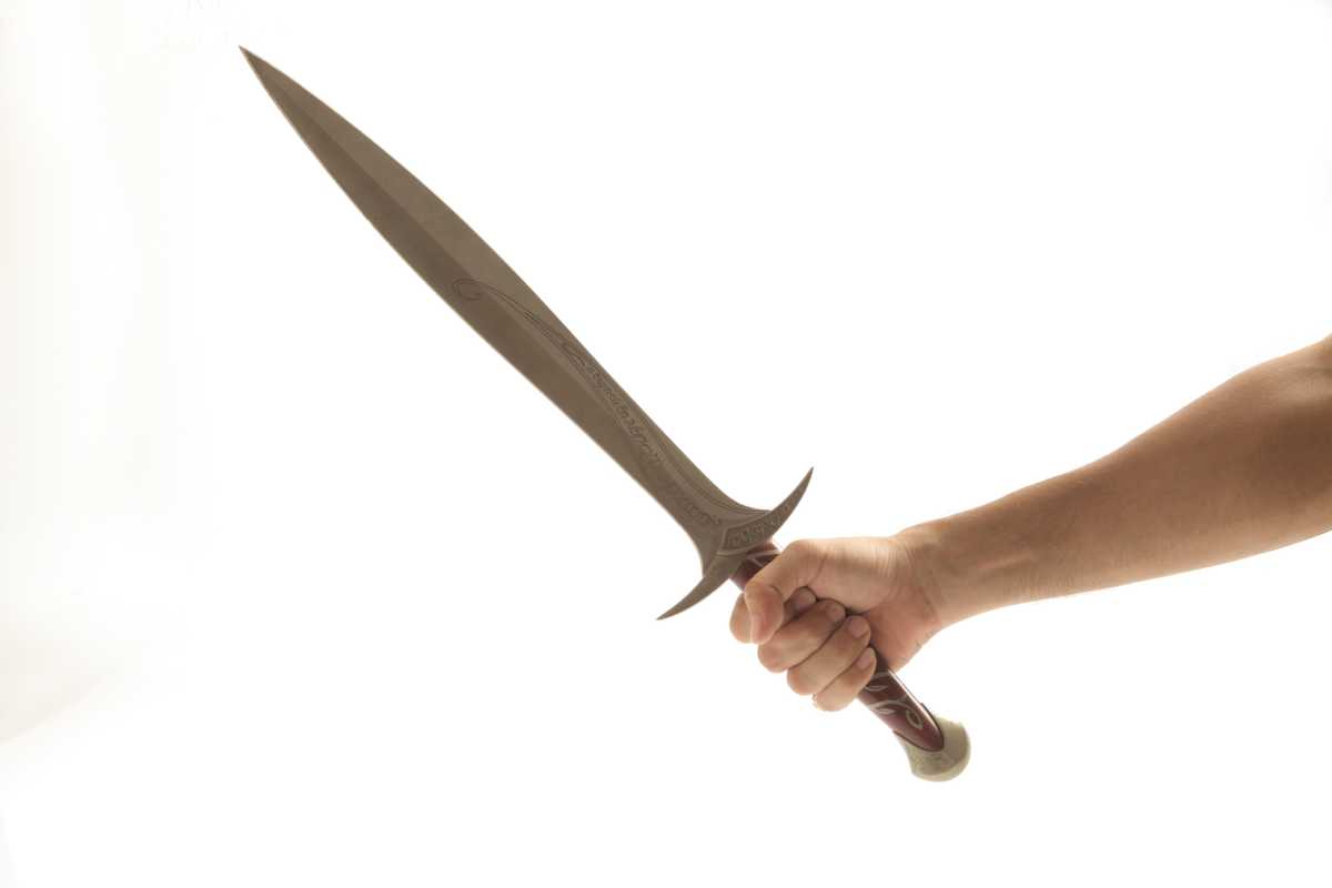 Hand holding an ancient sword