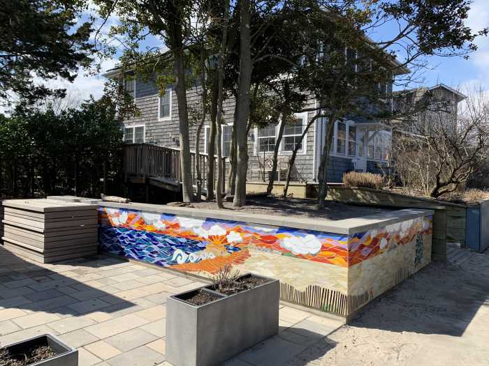 Along Ocean Breeze Walk in Ocean Beach, a vibrant, colored mosaic mural by mosaic artist Wendy Erdmann captures the wonders of Atlantic Coast sea life and Fire Island culture with the iconic red wagon and bike, which bestows the distinction as the land with no cars.