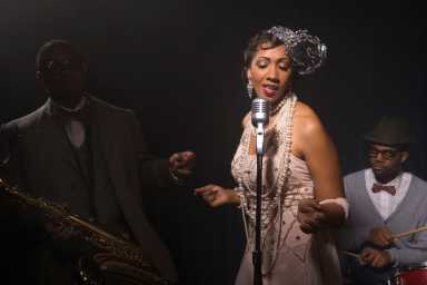 Singer performing with band in nightclub