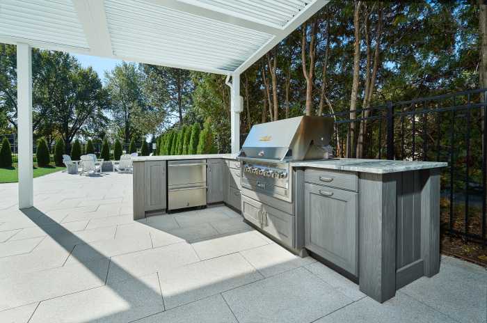 So, you just got home from a midsummer barbecue and pool party at your in-laws, and you were mesmerized by their awesome new outdoor kitchen. Now, the thought of needing one in your own yard simply won’t leave your mind. As the week goes on, at work, you’re constantly thinking about the great parties you’ll host with yours. The beautiful stonework that will enclose the new grill, refrigerator, wine cooler, kegerator, and sink suddenly becomes all that matters. After spending the weekend grilling on your boring standalone grill, having to run back inside to grab everything, that’s it, you decide you need a new outdoor kitchen like you need air.