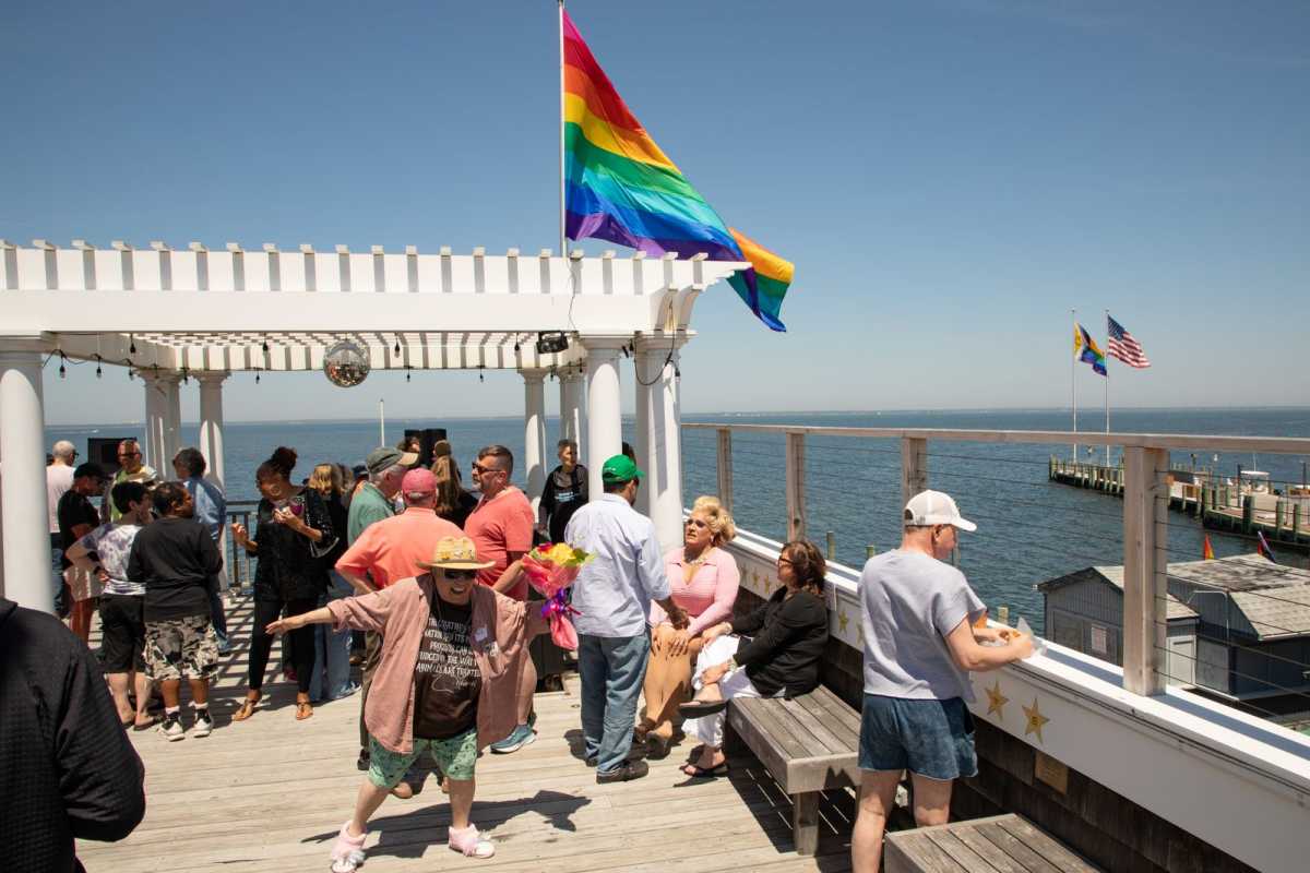 The Cherry Grove community gathered at the historic Community House & Theater to unveil and dedicate a new 60-foot Pride flag mast overlooking the Grove at the first meeting of the 2026 season for the Cherry Grove Community Association Inc. (CGCAI) on May 17.