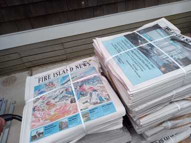 It may have been a gray, damp Thursday morning, with shops still busy making final touches as Memorial Day Weekend loomed large on Fire Island, but things felt a little warmer as vibrantly colored editions of Fire Island News (FIN) graced with the cover artwork of Margery Gosnell-Qua were loaded off the water taxi and onto wagons, and delivery rounds were made in Fire Island communities multiple communities including Atlatique, Cherry Grove, Davis Park, Fair Harbor, Fire Island Pines Kismet, Ocean Beach, Ocean Bay Park, and Saltaire.