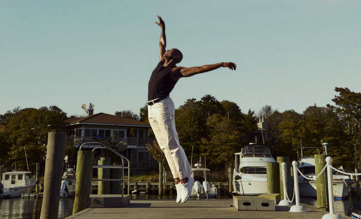 The Fire Island Dance Festival, returning July 18-19 to Fire Island Pines, is set on a waterfront stage overlooking the Great South Bay. The festival gathers extraordinary dancers in a place where salt air, open sky, and communal memory become part of the performance. Here, dance is not merely entertainment. It is witness, offering, and love made visible, moving from the stage into real life through meals, medication, counseling, emergency assistance, testing, grants, and care.